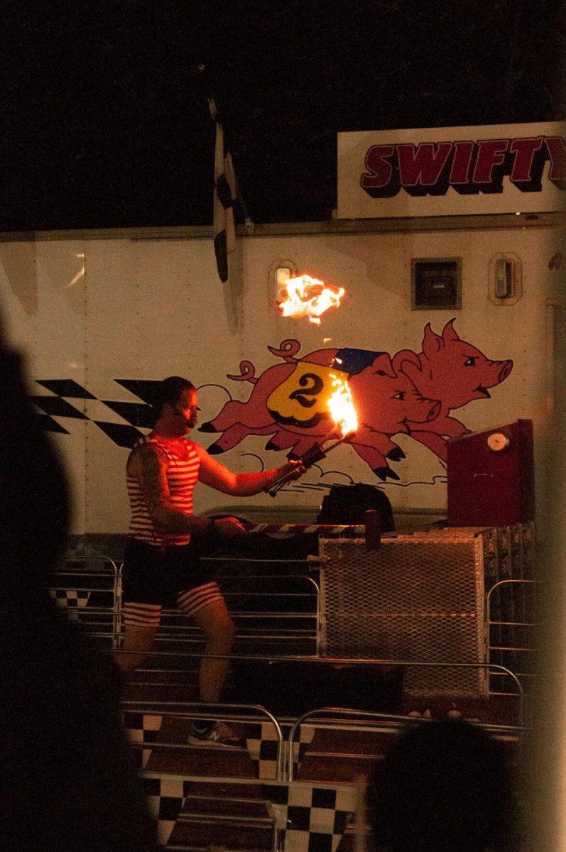 A showman juggles flaming axes at the Greater Baton Rouge State Fair on Sunday, Oct. 30, 2022, at the Lamar Dixon Expo Center in Gonzales, La.