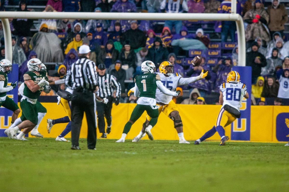 LSU football junior offensive line Anthony Bradford (75) and sophomore wide receiver Jack Bech (80) both reach for the ball on Saturday, Nov. 19, 2022, during the LSU vs. UAB game in Baton Rouge, La.