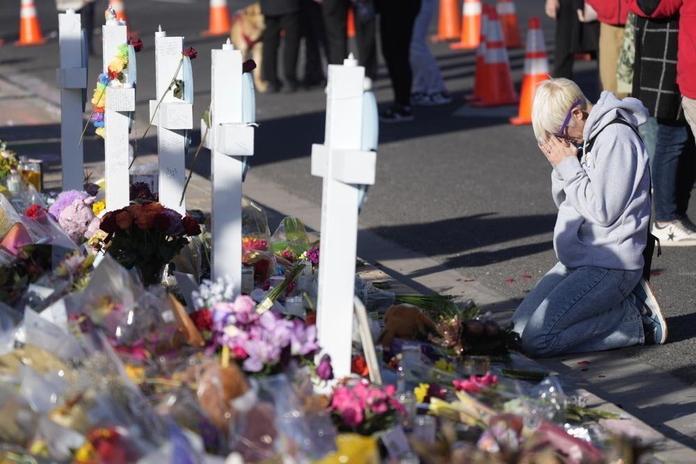 FILE - Dallas Dutka of Broomfield, Colo., prays by a makeshift memorial, Nov. 22, 2022, for the victims of a mass shooting at a gay nightclub in Colorado Springs, Colo. Dutka's cousin, Daniel Aston, was killed in the shooting.&#160;