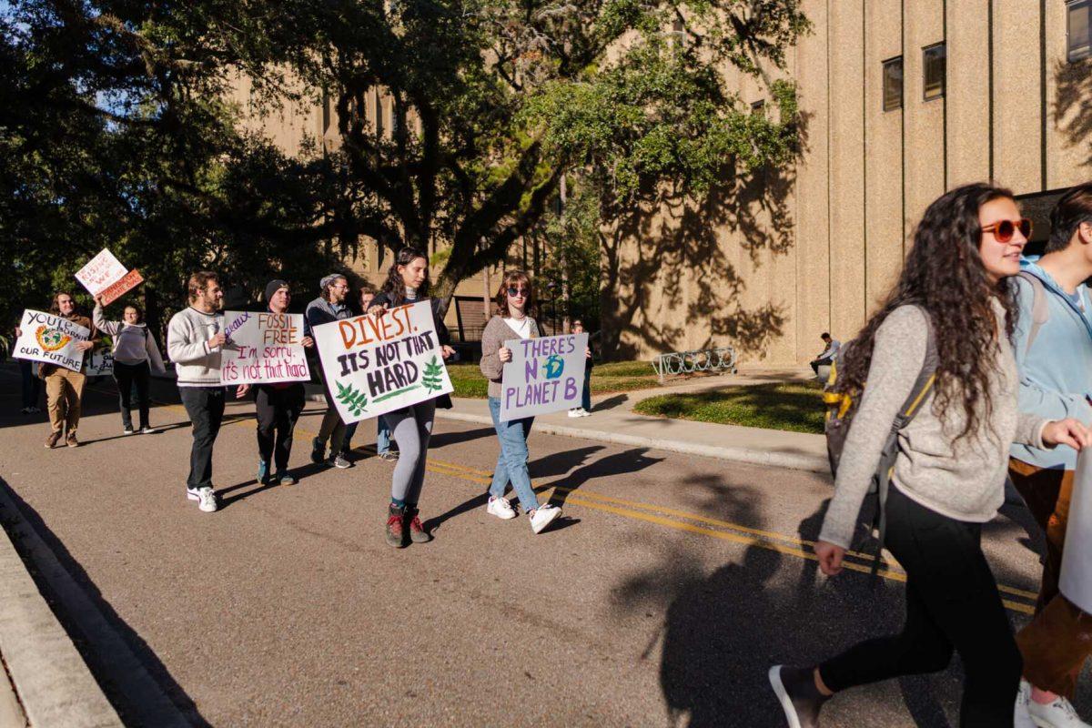 Demonstrators march on Friday, Nov. 18, 2022, past Williams Hall on Tower Drive in Baton Rouge, La.