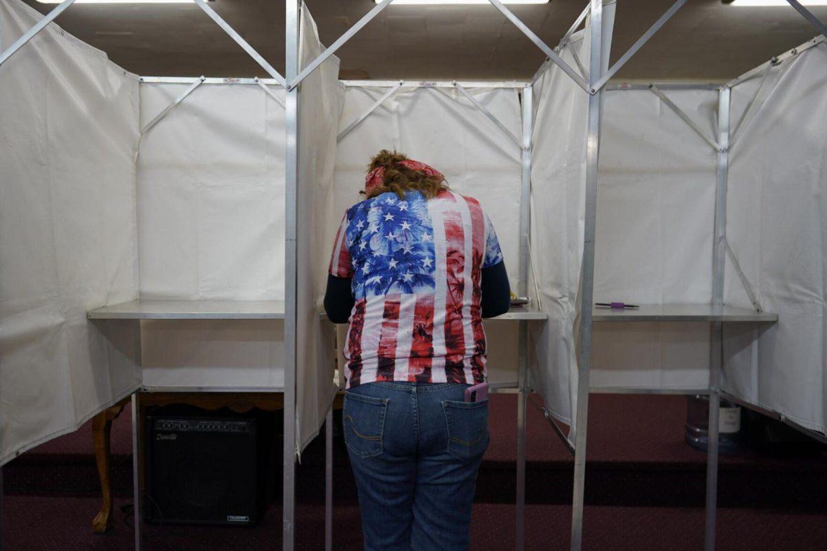 Loretta Myers fills out her ballot at her polling place, the New LIFE Worship Center Church of God, in Fayetteville, Pa., Tuesday, Nov. 8, 2022.