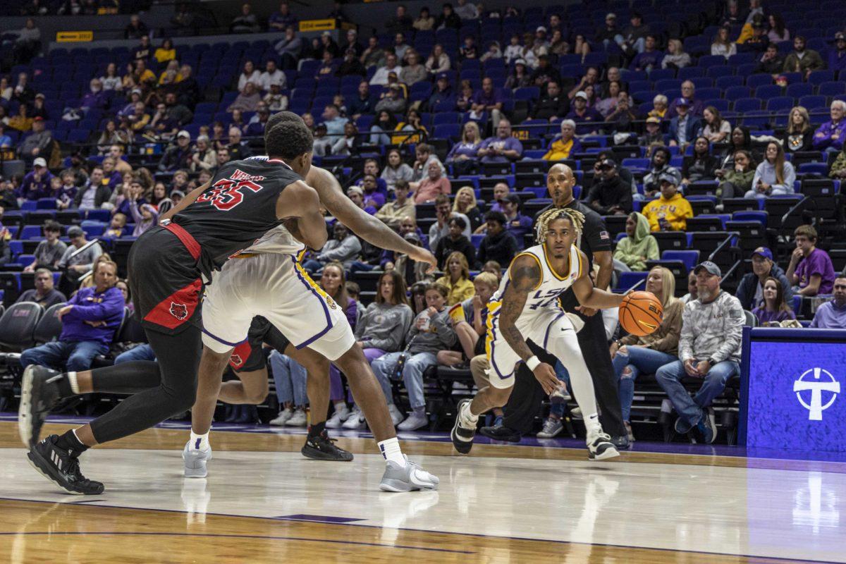 LSU basketball sophomore guard Adam Miller (44) searches for a way through Arkansas players Saturday, Nov. 12, 2022, during LSU's 61-52 victory over Arkansas State at the Pete Maravich Assembly Center on N. Stadium Drive.