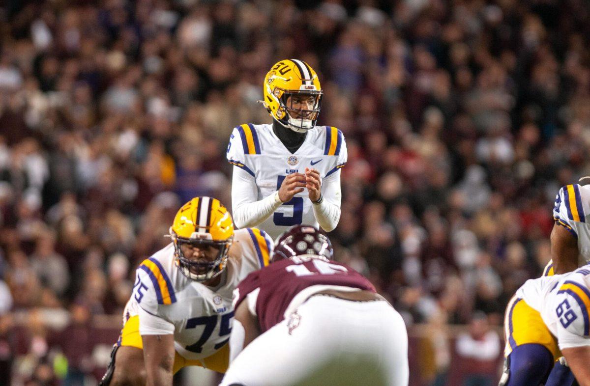 LSU football junior quarterback Jayden Daniels (5) glances at his offense on Saturday, Nov. 26, 2022, during LSU's 23-38 loss against Texas A&amp;M at Kyle Field.