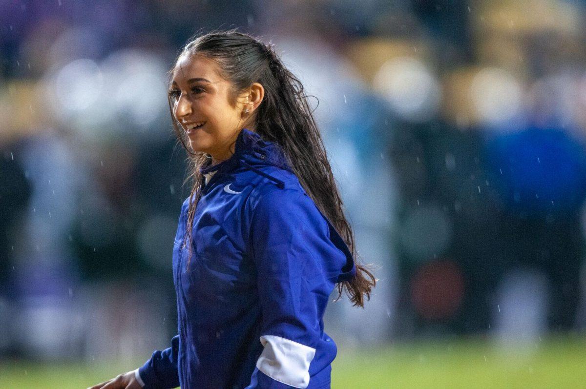 A Tiger Girl smiles at the crowd after performing on Saturday, Nov. 19, 2022, inside Tiger Stadium in Baton Rouge, La.