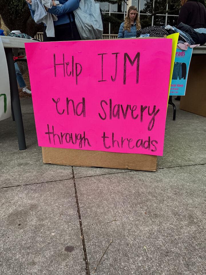 A sign reads "Help IJM end slavery through threads" on Wednesday, Nov. 16, 2022, in front of the LSU Student Union in Baton Rouge, La.