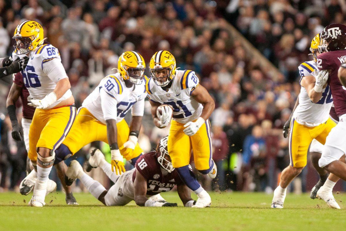 LSU football junior running back Noah Cain (21) darts down the field on Saturday, Nov. 26, 2022, during LSU's 23-38 loss against Texas A&amp;M at Kyle Field.