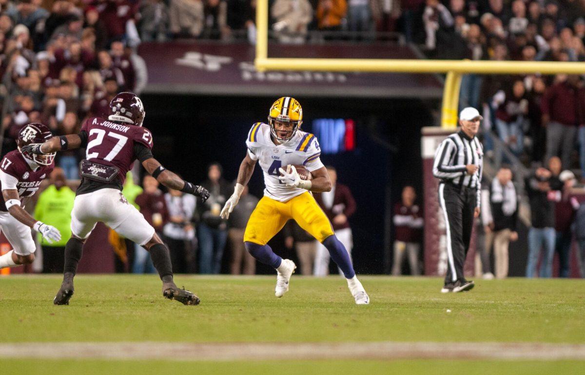 LSU football senior running back John Emery Jr. (4) rushes the ball down the field on Saturday, Nov. 26, 2022, during LSU's 23-38 loss against Texas A&amp;M at Kyle Field.