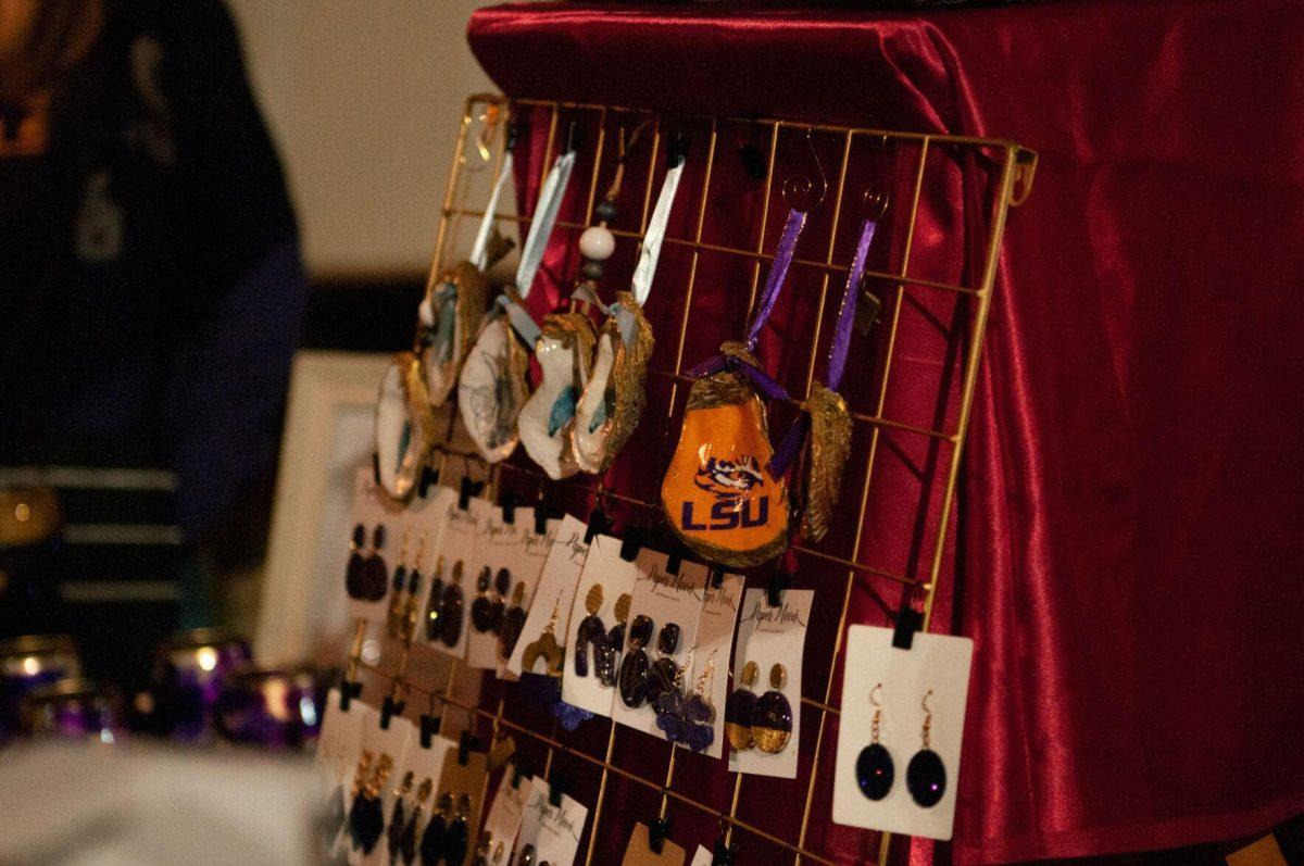 Christmas ornaments made from oyster shells and purple and gold earrings are displayed for sale on Friday, Nov. 18, 2022, at Mid City Merchant's White Light Night on Government Street in Baton Rouge, La.