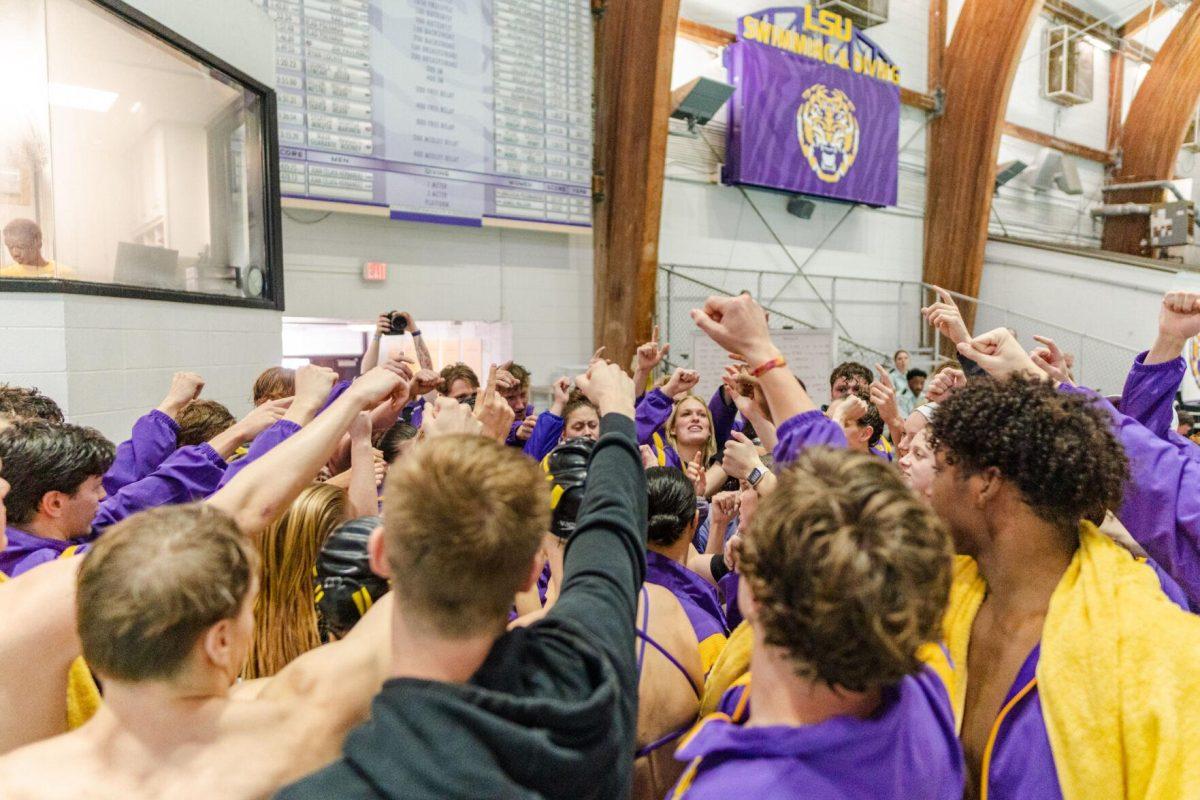 The LSU swim team huddles up on Friday, Nov. 4, 2022, prior to their loss to Alabama at the LSU natatorium in Baton Rouge, La.