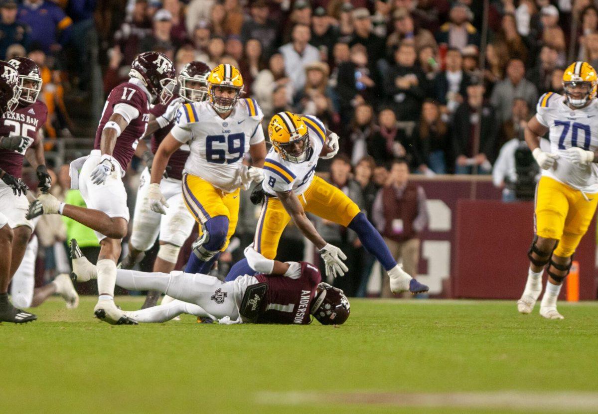 LSU football sophomore wide receiver Malik Nabers (8) fights to stay standing on Saturday, Nov. 26, 2022, during LSU's 23-38 loss against Texas A&amp;M at Kyle Field.