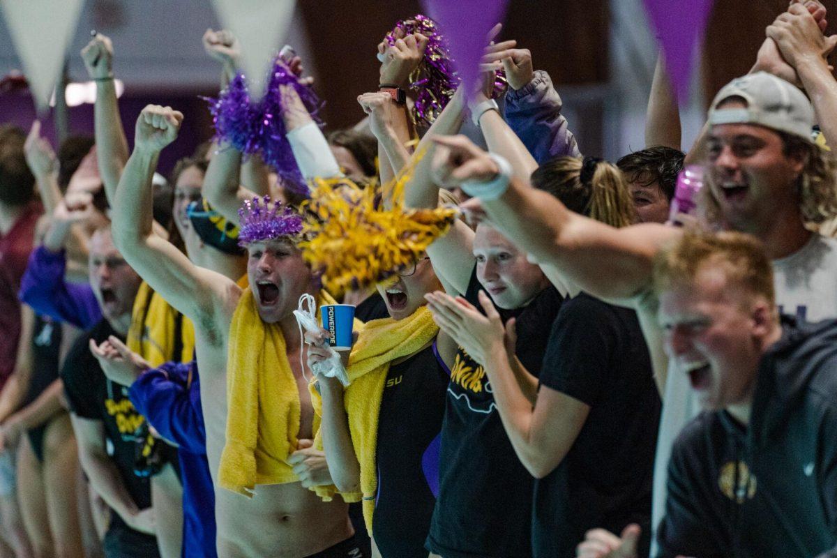 The LSU swim team cheers for their teammates on Friday, Nov. 4, 2022, during their loss to Alabama at the LSU natatorium in Baton Rouge, La.