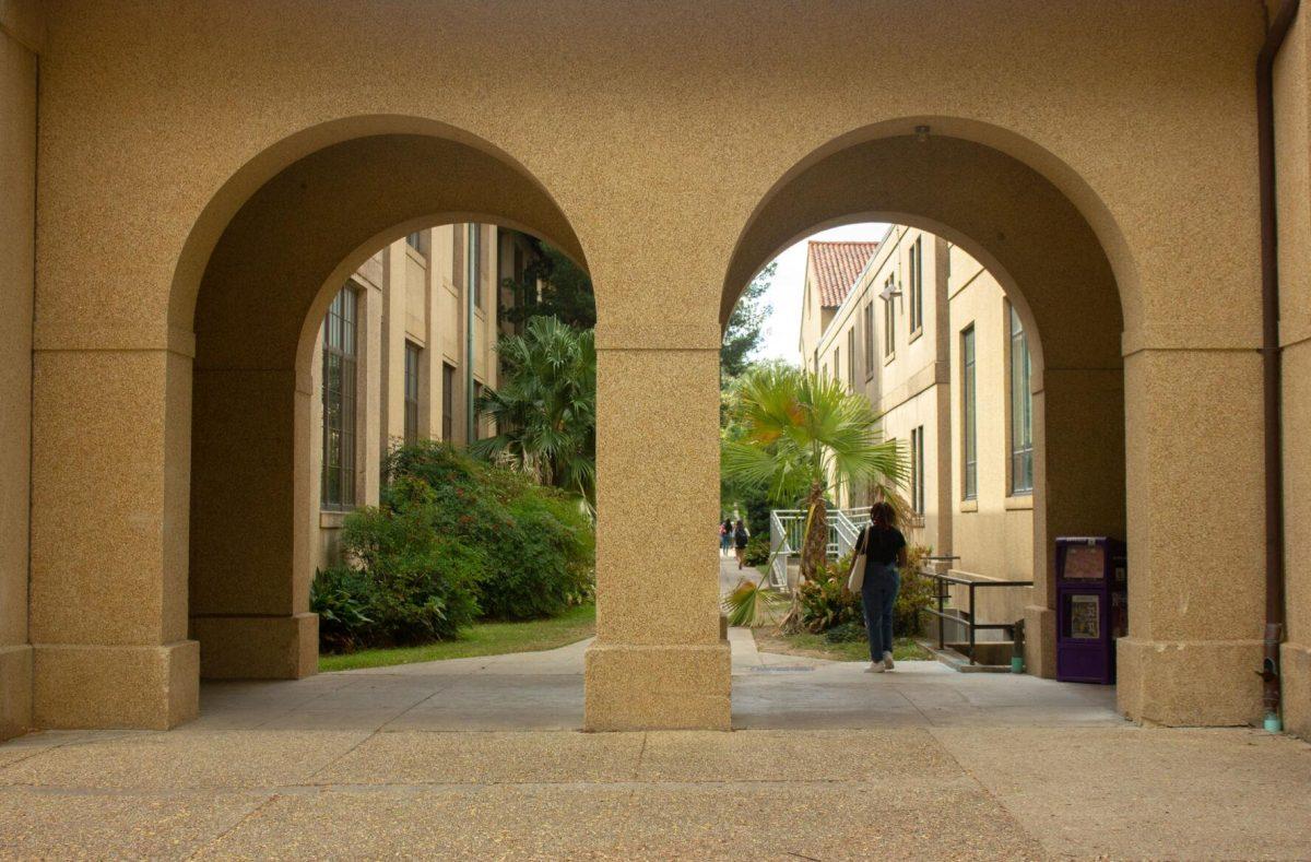 An LSU student walks under one of the two archways on Monday, Nov. 7, 2022, in the Quad in Baton Rouge, La.