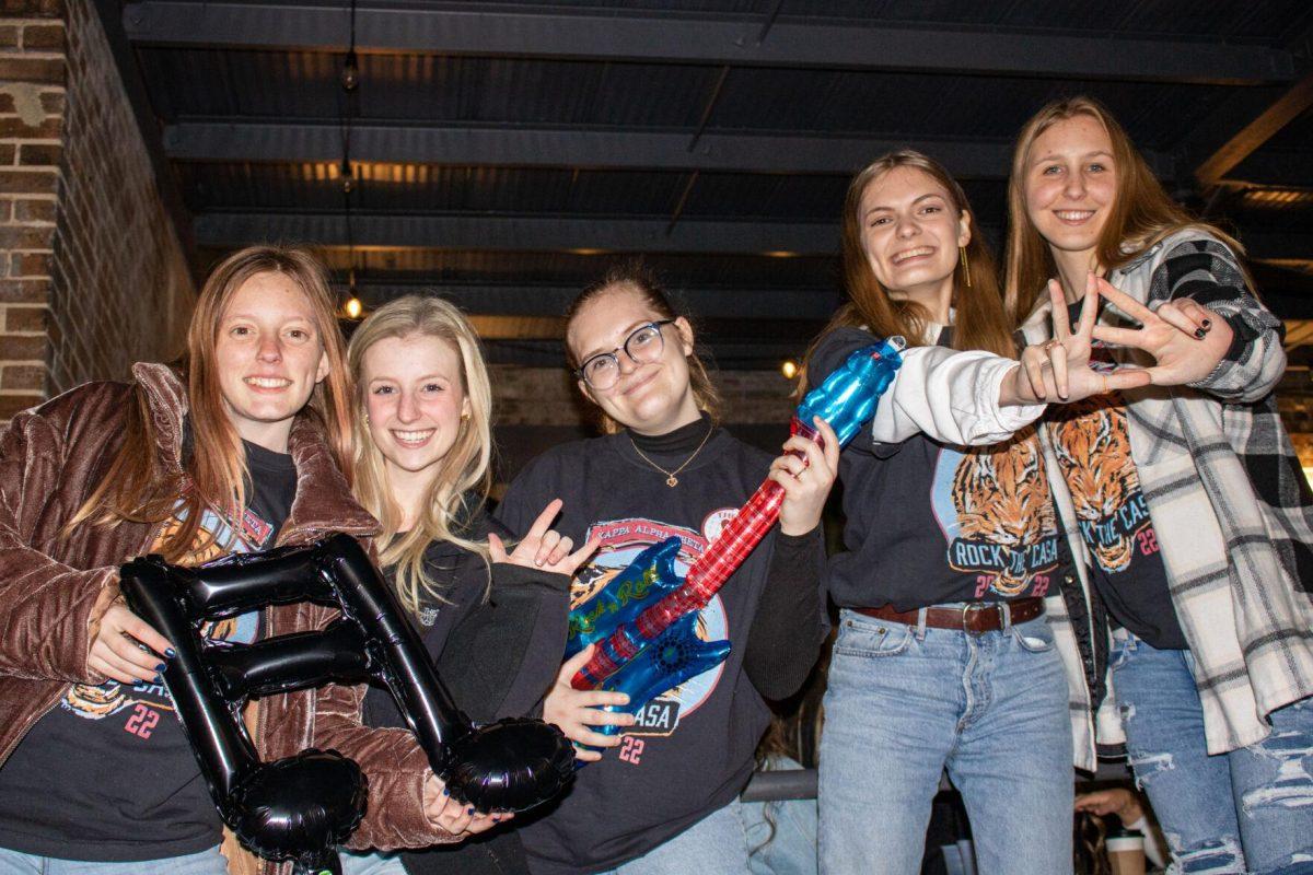 Members of Kappa Alpha Theta pose with props on Friday, Nov. 18, 2022, at Red Stick Social on Government Street in Baton Rouge, La.