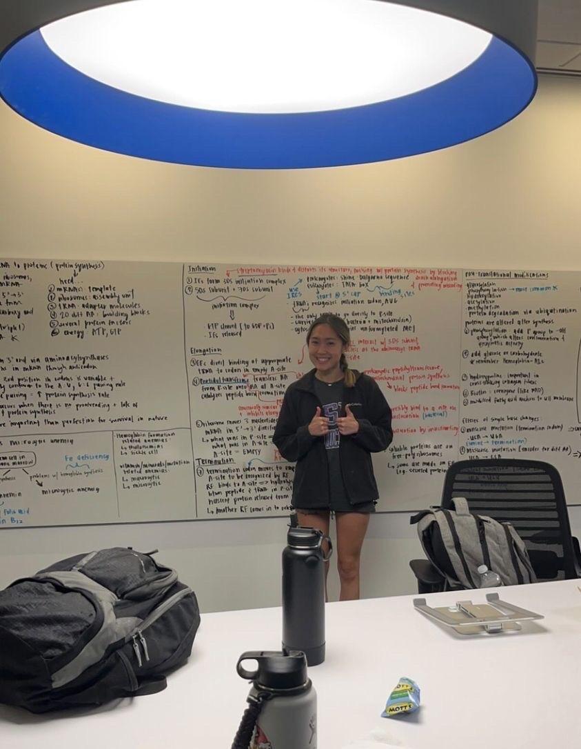 Calli Nguyen poses with her study notes at Baylor College of Medicine.