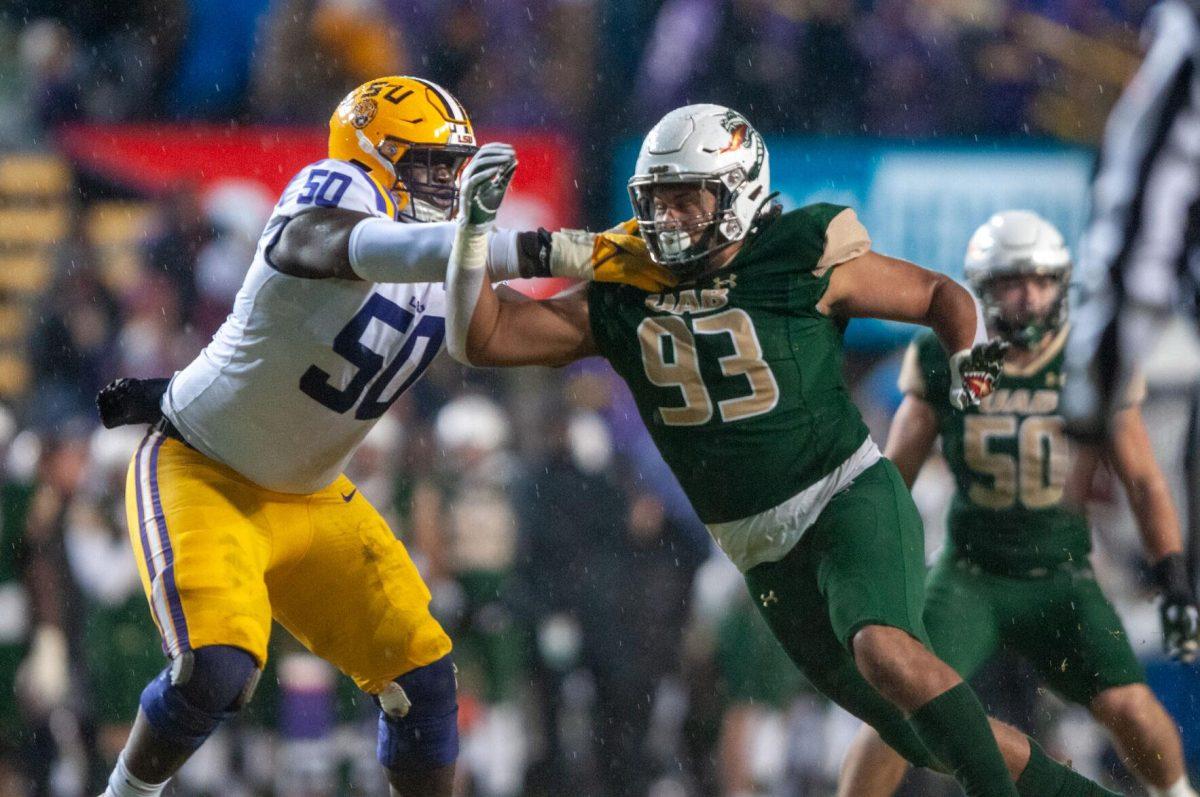 LSU football freshman offensive line Emery Jones Jr. (50) lunges at UAB football junior outside linebacker Michael Fairbanks II (93) on Saturday, Nov. 19, 2022, inside Tiger Stadium in Baton Rouge, La.