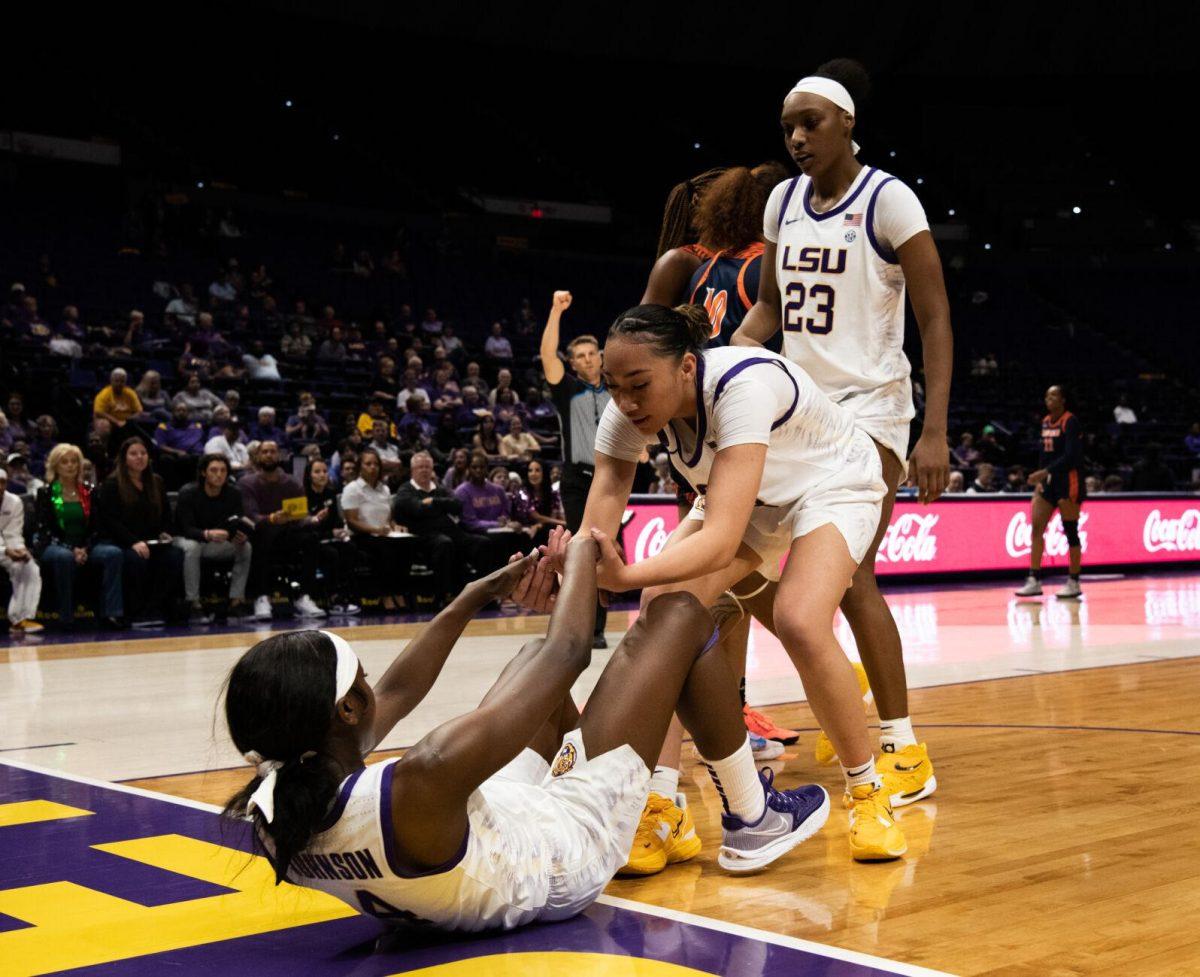 LSU women&#8217;s basketball Last-Tear Poa (13) helps up Flau&#8217;jae Johnson (4) during LSU&#8217;s 121-46 win in an exhibition game against Langston University on Thursday, Nov. 3, 2022, in the Pete Maravich Assembly Center on N. Stadium Drive in Baton Rouge, La.