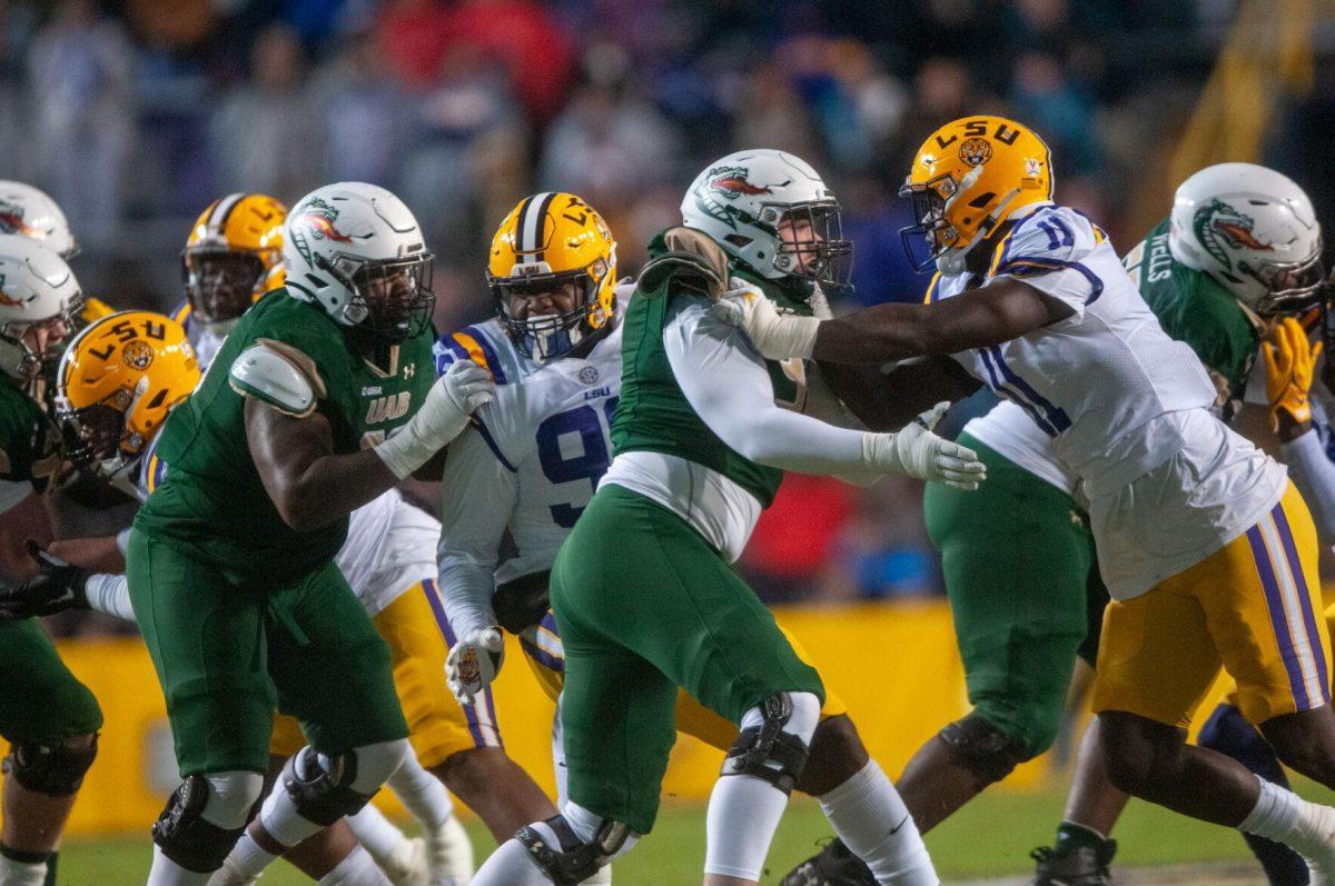 LSU and UAB football players tackle one another on Saturday, Nov. 19, 2022, during the LSU vs. UAB in Baton Rouge, La.