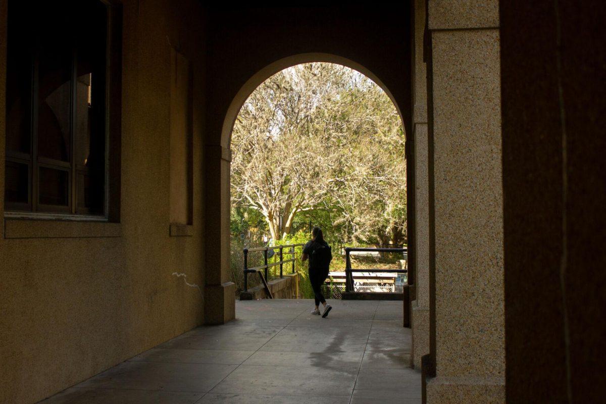 A student walks away from the archway on Monday, Nov. 7, 2022, near Peabody Hall in Baton Rouge, La.