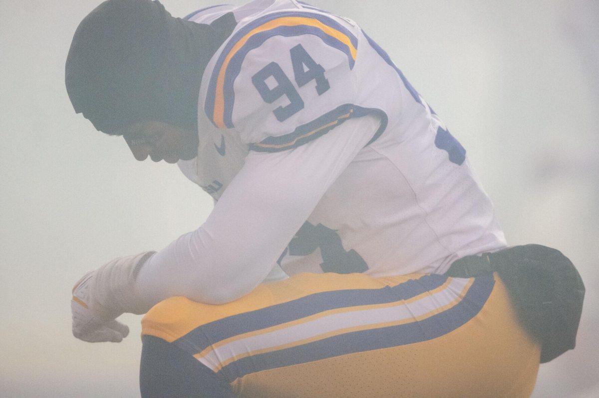 LSU football freshman defensive end Princeton Malbrue (94) kneels in the smoke from the cannons on Saturday, Nov. 19, 2022, right before game-time inside Tiger Stadium in Baton Rouge, La.