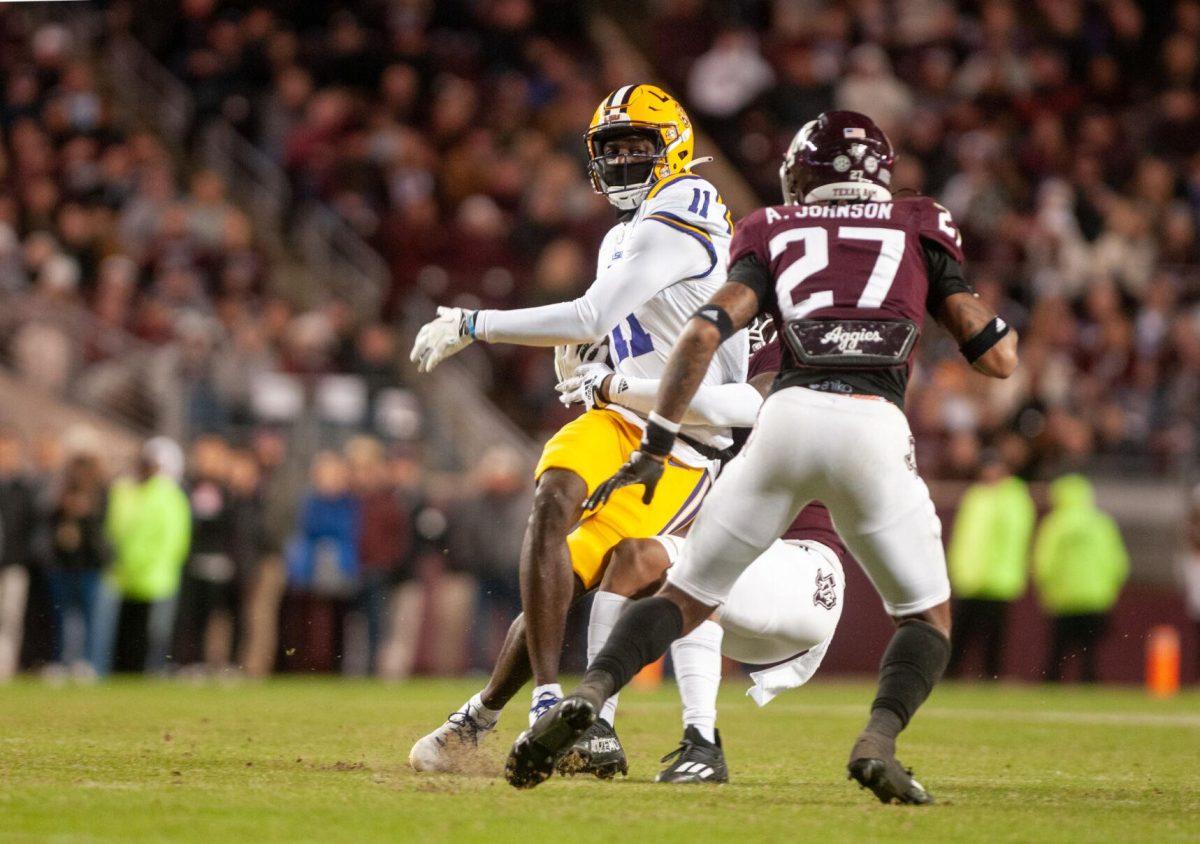 LSU football sophomore wide receiver Brian Thomas Jr. (11) fights against the defense on Saturday, Nov. 26, 2022, during LSU's 23-38 loss against Texas A&amp;M at Kyle Field.