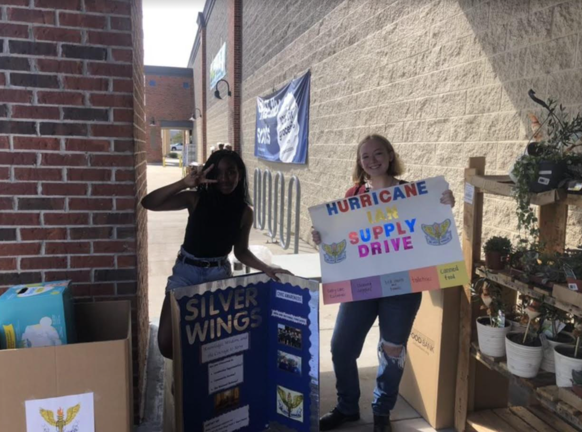 International Studies Junior Madison Trahan (left) and criminology sophomore Kendall Sessoms (right) collecting goods outside grocery store.