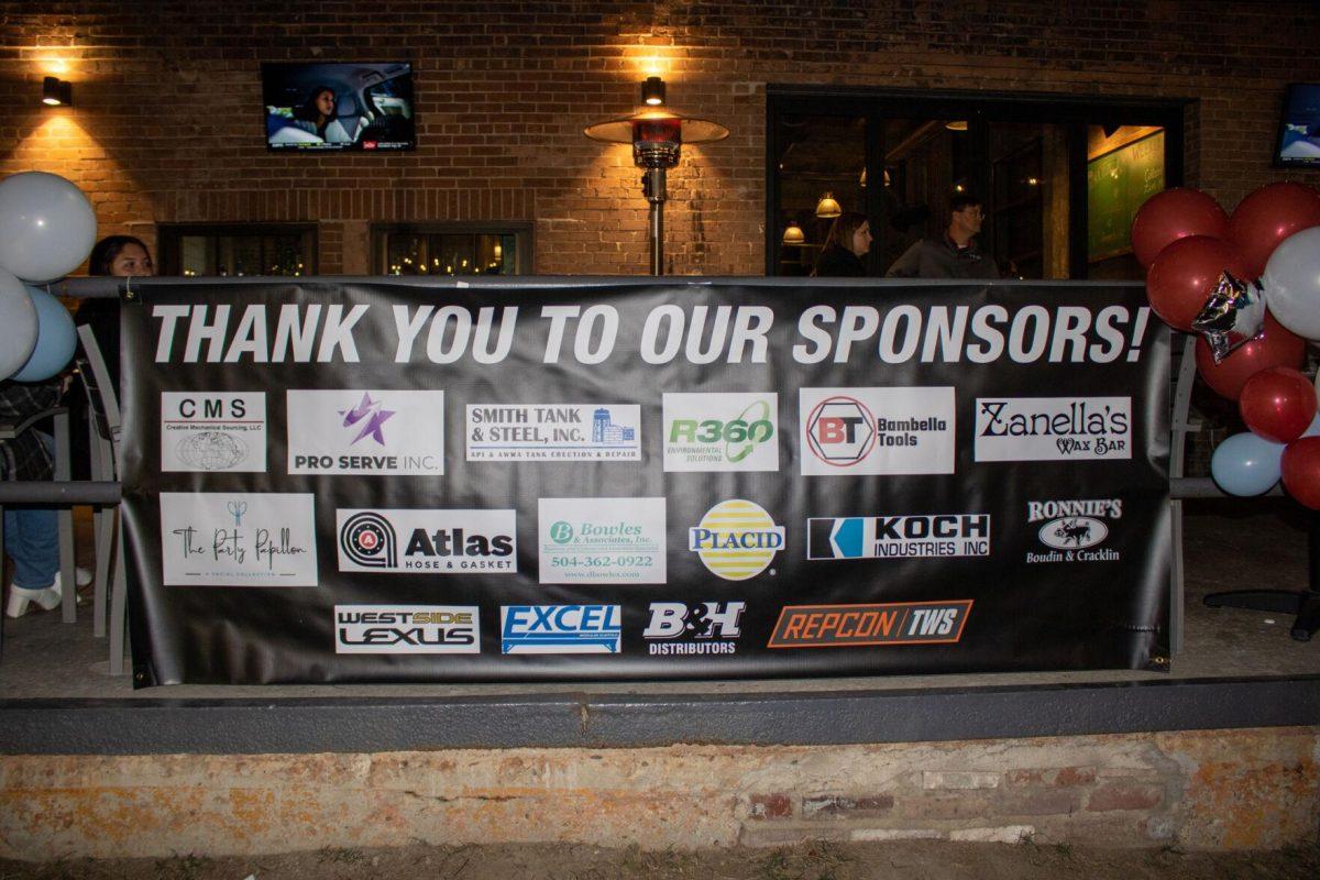 A banner hangs showcasing all the different companies that sponsor the Rock the CASA event on Friday, Nov. 18, 2022, at Red Stick Social on Government Street in Baton Rouge, La.