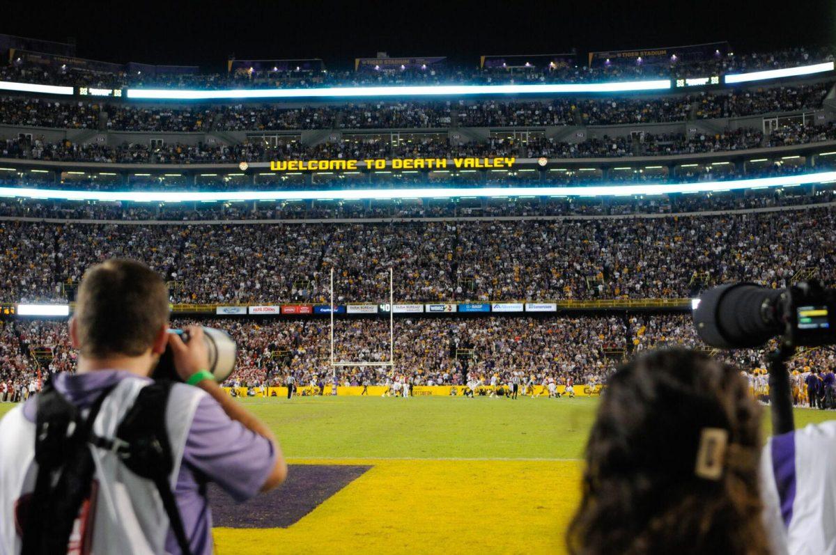 Photographers Hilton Eymard and Reagan Cotten wait for the perfect shot during a fourth quarter play on Saturday, Nov. 5, 2022, during LSU&#8217;s 32-31 victory over Alabama in Tiger Stadium in Baton Rouge, La.