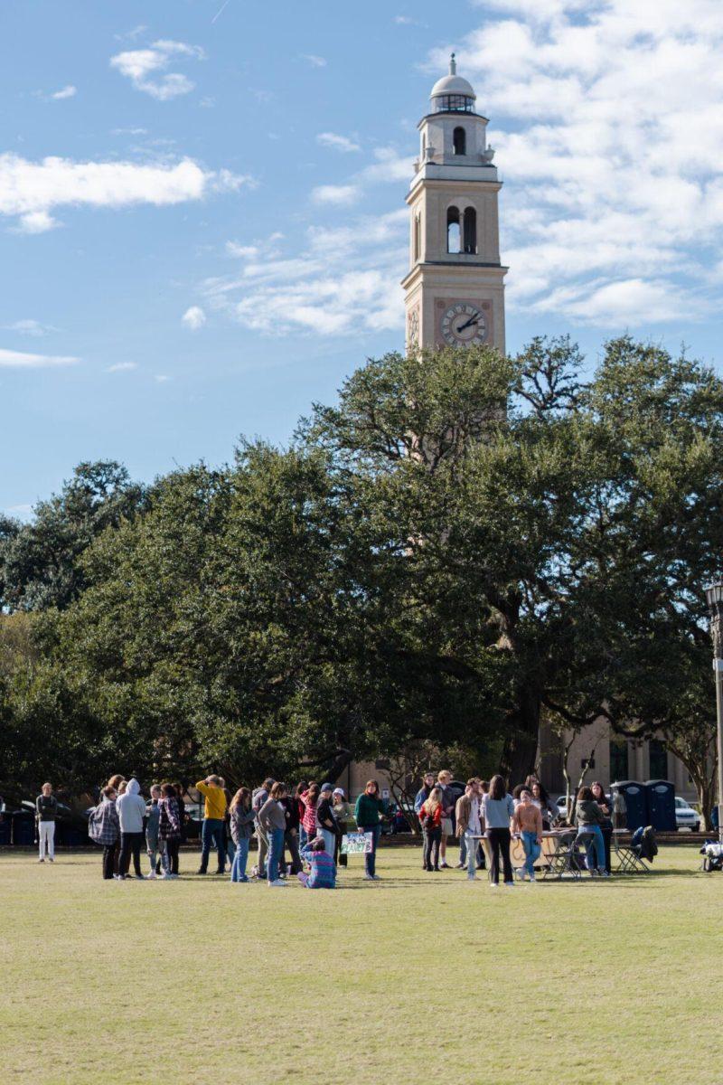 Rally participants gather on Friday, Nov. 18, 2022, on the LSU Parade Ground before the march begins.