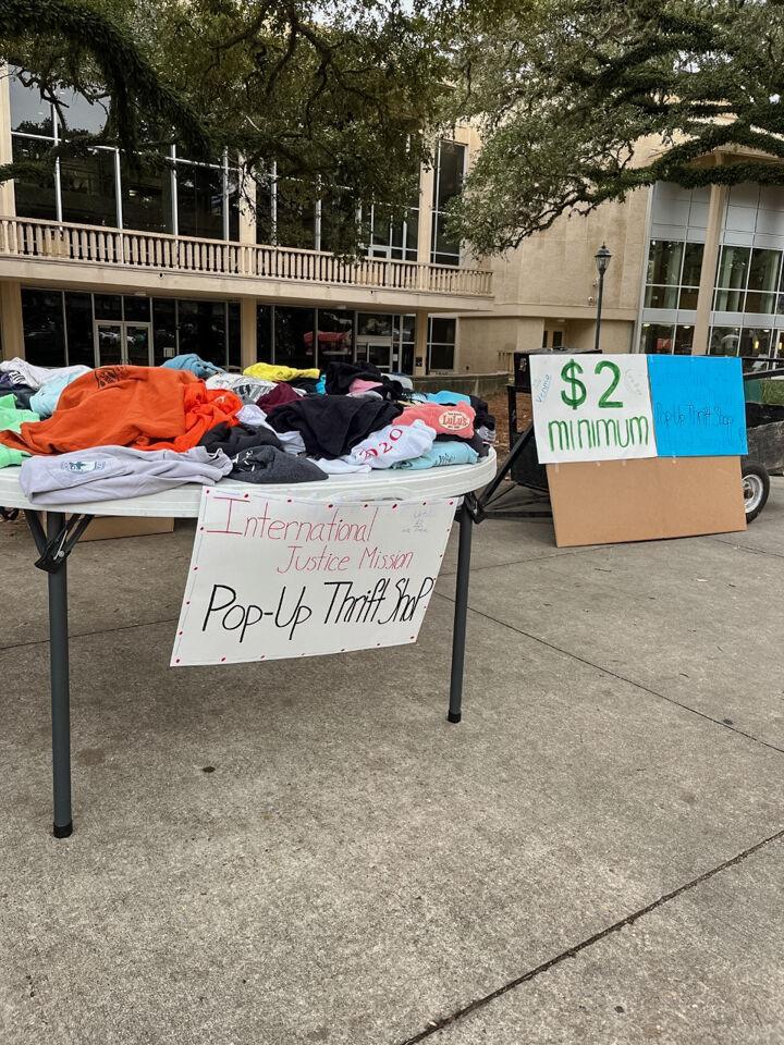 Clothing sits atop a table on Wednesday, Nov. 16, 2022, for the International Justice Mission thrifting event outside the LSU Student Union in Baton Rouge, La.