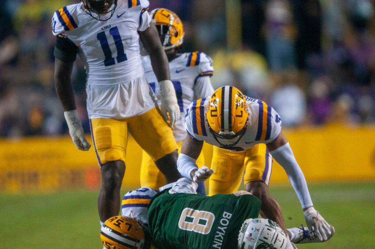 LSU football senior safety Greg Brooks Jr. (3) tackles UAB football senior wide receiver Dexter Boykin (8) on Saturday, Nov. 19, 2022, during the LSU vs UAB game in Baton Rouge, La.