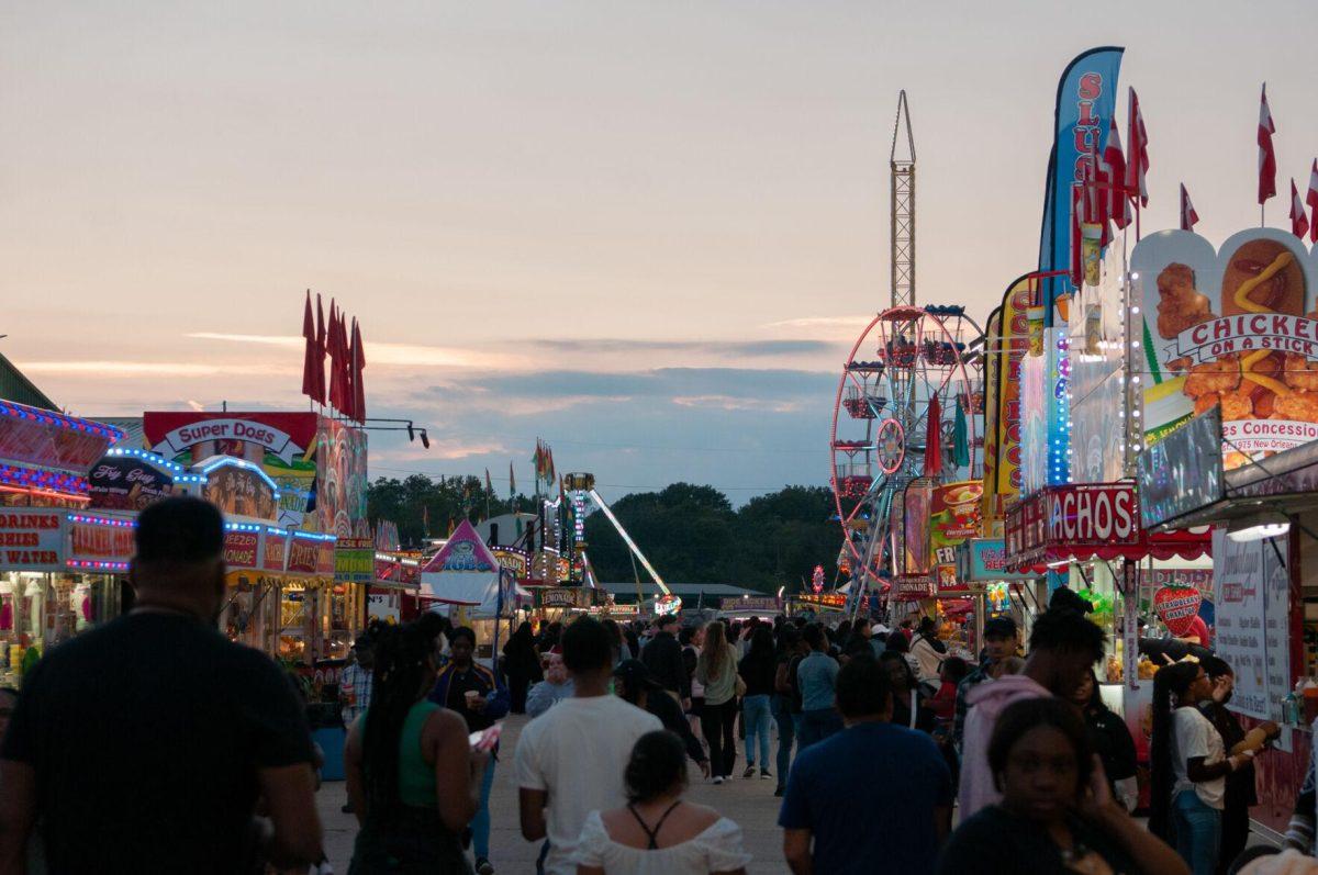 An aisle created by food vendors directs guests to rides and games at the Greater Baton Rouge State Fair on Sunday, Oct. 30, 2022, at the Lamar Dixon Expo Center in Gonzales, La.