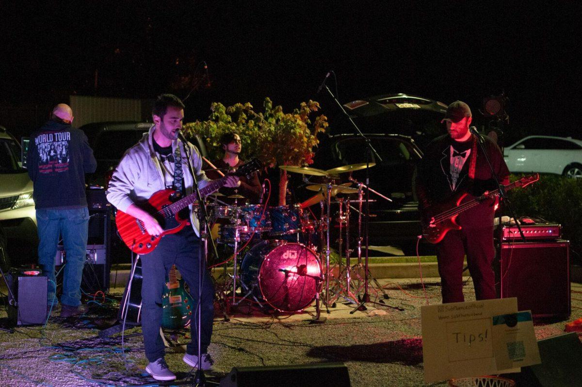 A four-piece band plays music for guests to enjoy on Friday, Nov. 18, 2022, at Mid City Merchant's White Light Night on Government Street in Baton Rouge, La.