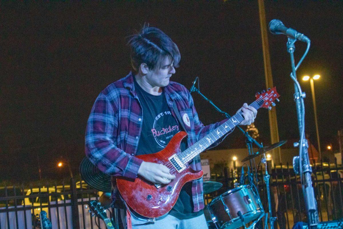 The guitarist, Kade Simar, of WaveRunner performs with a Theta loves CASA sticker on Friday, Nov 18, 2022 at Red Stick Social on Government Dr in Baton Rouge, La.