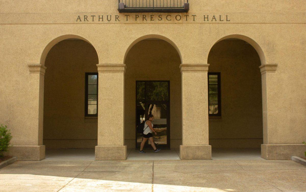 An LSU student walks under the arch on Monday, Nov. 7, 2022, in front of Arthur T. Prescott hall in the Quad in Baton Rouge, La.