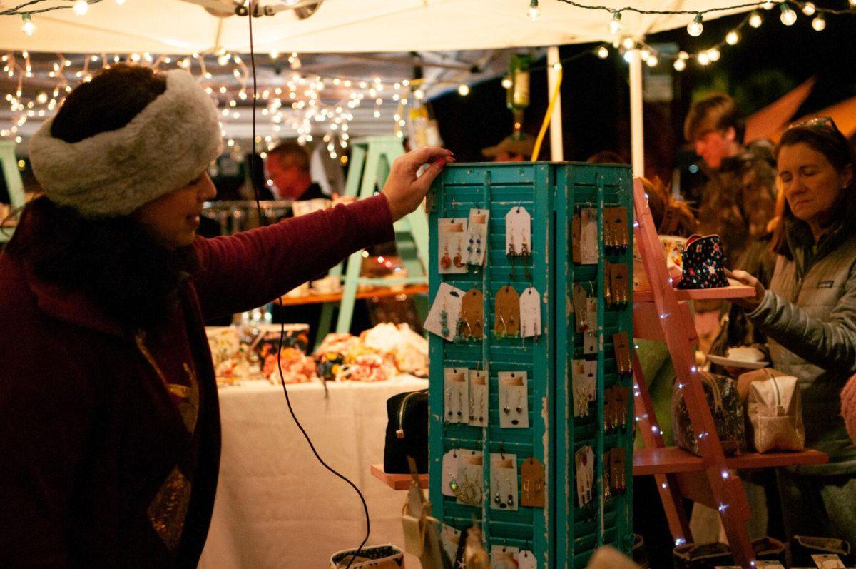 A vendor spins her earring display on Friday, Nov. 18, 2022, at Mid City Merchant's White Light Night on Government Street in Baton Rouge, La.