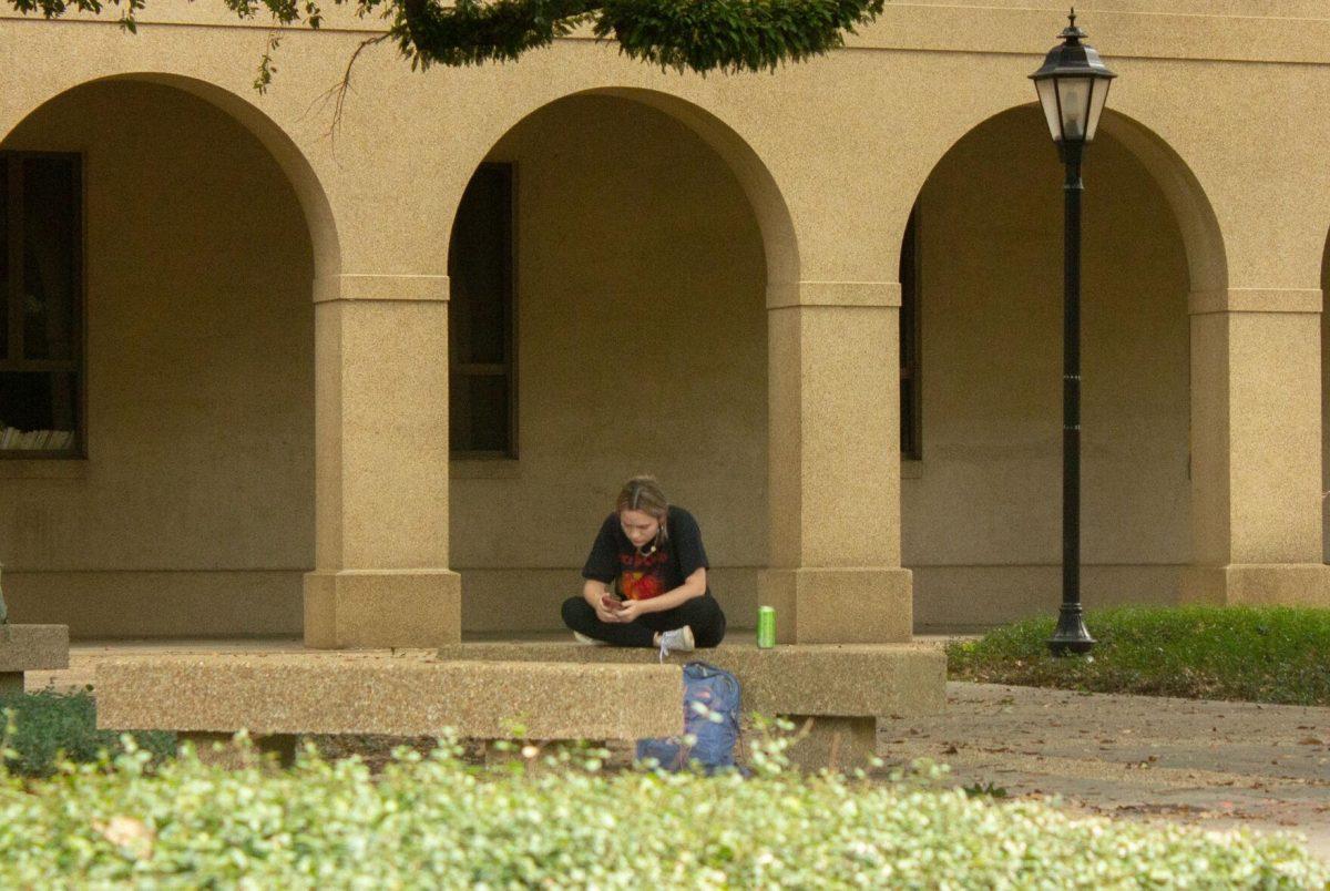 An LSU student sits on Monday, Nov. 7, 2022, in the Quad in Baton Rouge, La.