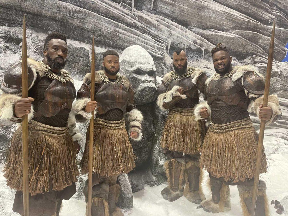 LSU 2015 alumnus Floyd Anthony Johns Jr. (second from left) stands on the set of "Black Panther: Wakanda Forever" in his Jabari Warrior costume.&#160;