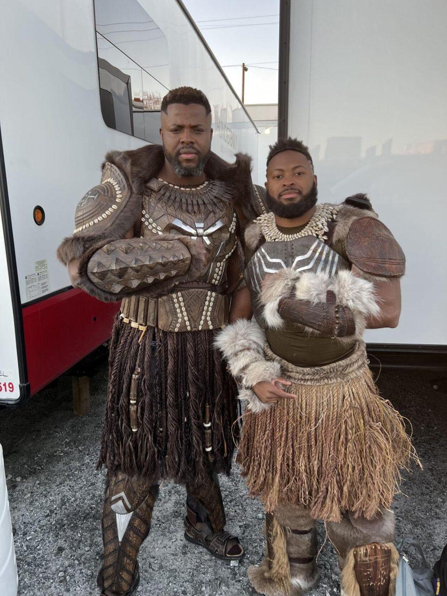 Floyd Anthony Johns Jr. takes a photo with actor Winston Duke, who portrays M'Baku in "Black Panther: Wakanda Forever."