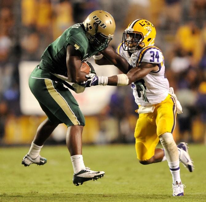 LSU sophomore safety Micah Eugene (34) tackles UAB freshman running back Jordon Howard (7) on Sept. 7, 2013 during the Tigers' 56-17 victory against the Blazers in Tiger Stadium.