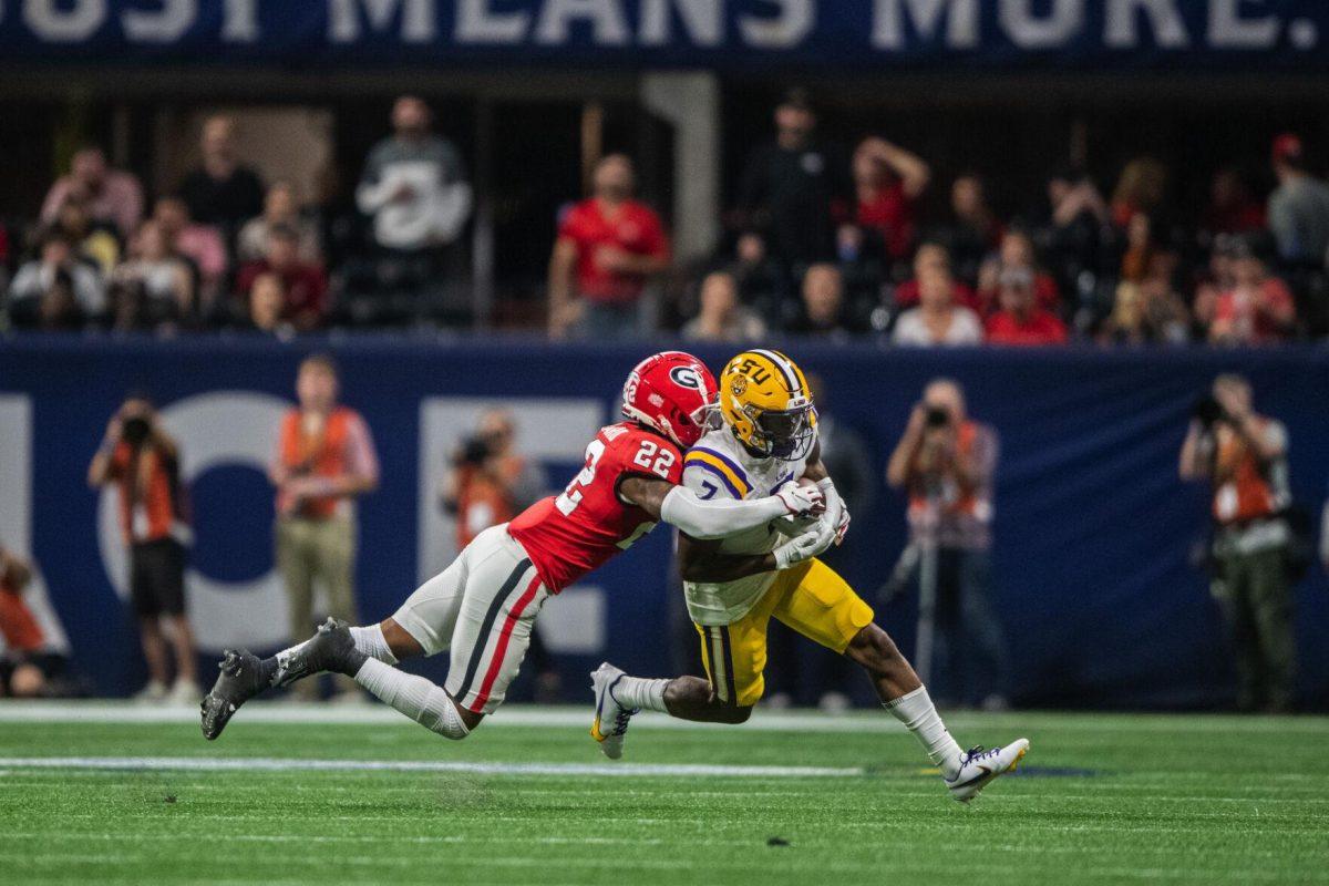 LSU football junior wide receiver Kayshon Boutte (7) braces for a tackle from Georgia sophomore defensive back Javon Bullard (22) Saturday, Dec. 3, 2022, during LSU's 30-50 defeat to Georgia at the Southeastern Conference Championship in the Mercedes-Benz Stadium in Atlanta, Georgia.