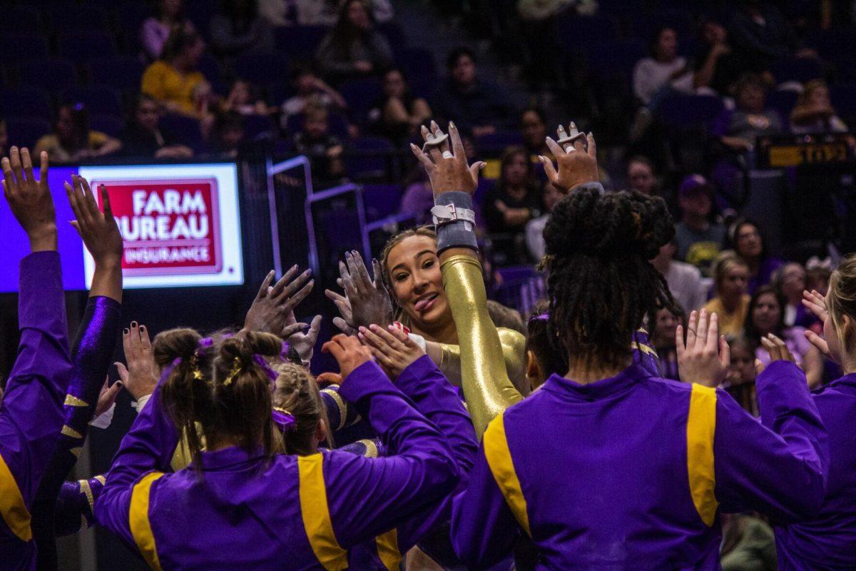 LSU gymnastics senior all-around Alyona Shchennikova celebrates with her teammates after completing her uneven bars routine Monday, Dec. 12, 2022, during the annual "Gym 101" showcase in the Pete Maravich Assembly Center.