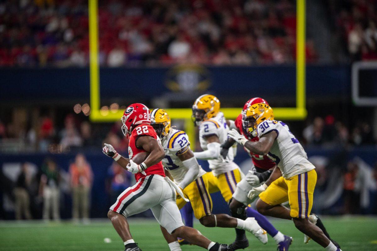 LSU football players chase down Georgia freshman tailback Branson Robinson (22) Saturday, Dec. 3, 2022, during LSU's 30-50 defeat to Georgia at the Southeastern Conference Championship in the Mercedes-Benz Stadium in Atlanta, Georgia.