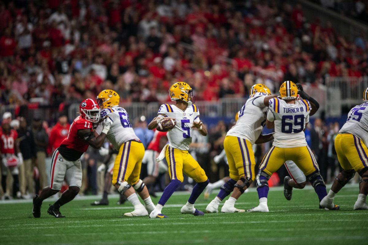 LSU football junior quarterback Jayden Daniel (5) prepares to make a pass Saturday, Dec. 3, 2022, during LSU's 30-50 defeat to Georgia at the Southeastern Conference Championship at the Mercedes-Benz Stadium in Atlanta, Georgia.