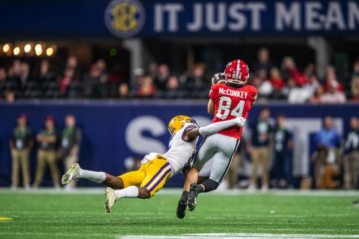 LSU football sophomore safety Jay Ward (5) pounces on Georgia red-shirt wide receiver Ladd McConkey (84) Saturday, Dec. 3, 2022, during LSU's 30-50 defeat to Georgia at the Southeastern Conference Championship at the Mercedes-Benz Stadium in Atlanta, Georgia.