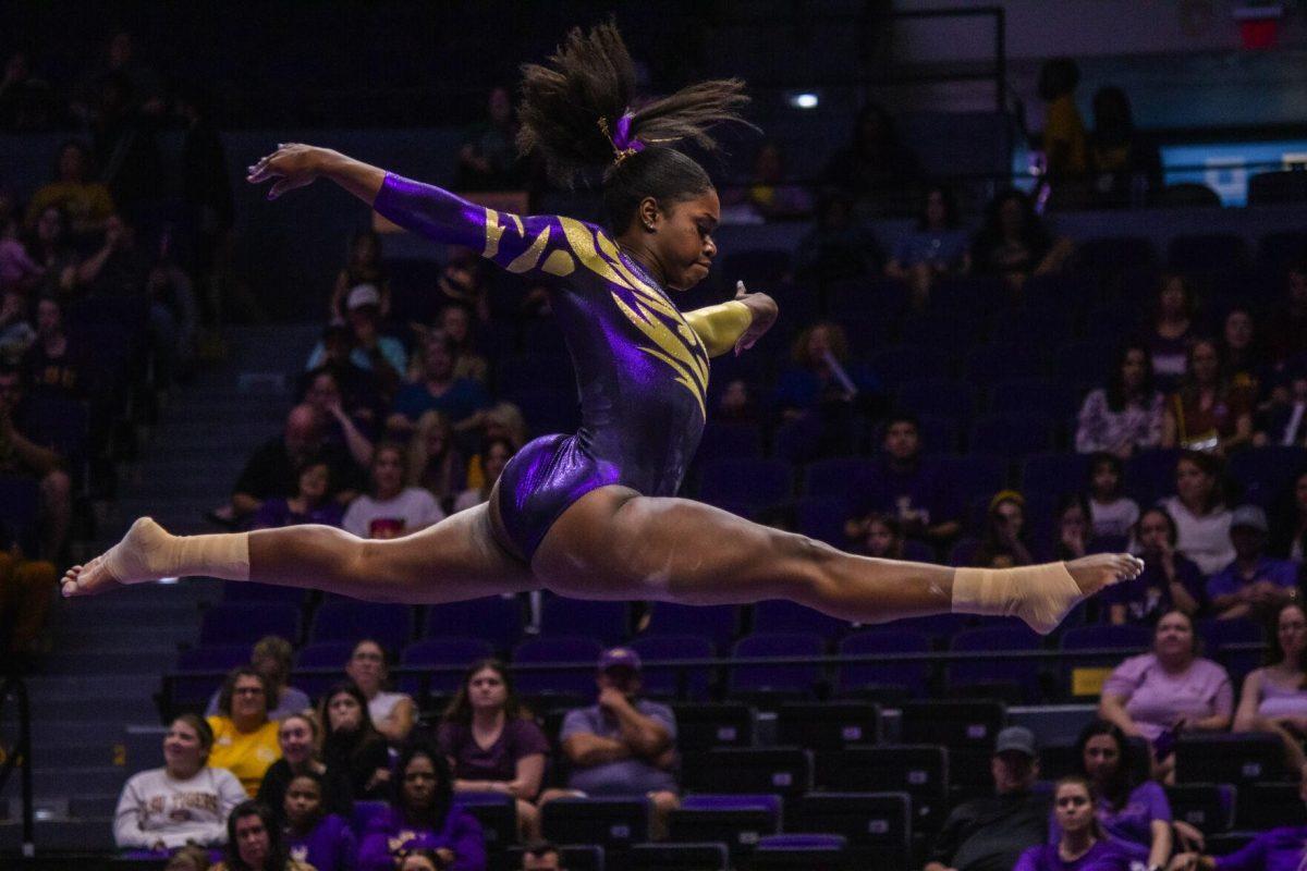 LSU gymnastics senior all-around Kiya Johnson leaps across the balance beam Monday, Dec. 12, 2022, during the annual "Gym 101" showcase in the Pete Maravich Assembly Center.