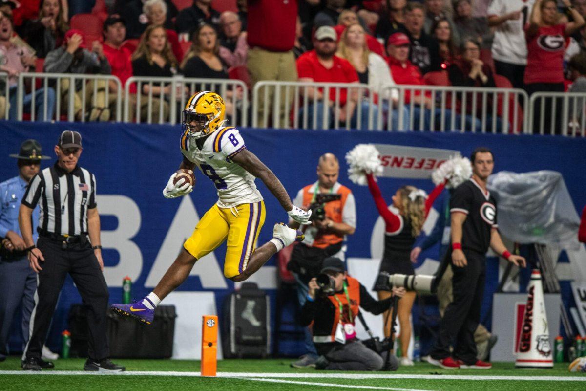 LSU football sophomore wide receiver Malik Nabers (8) jumps into the end zone Saturday, Dec. 3, 2022, during LSU's 30-50 defeat to Georgia at the Southeastern Conference Championship at the Mercedes-Benz Stadium in Atlanta, Georgia.