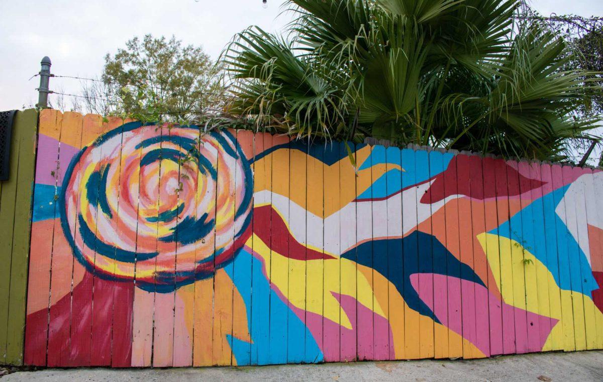 A colorful flower mural covers a fence on Friday, Dec 2, 2022, on South 19th St. in Baton Rouge, La.