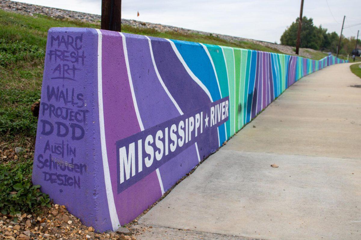 A colorful mural lines the road and the Mississippi River on Friday, Dec 2, 2022, on Laurel St. in downtown Baton Rouge, La.