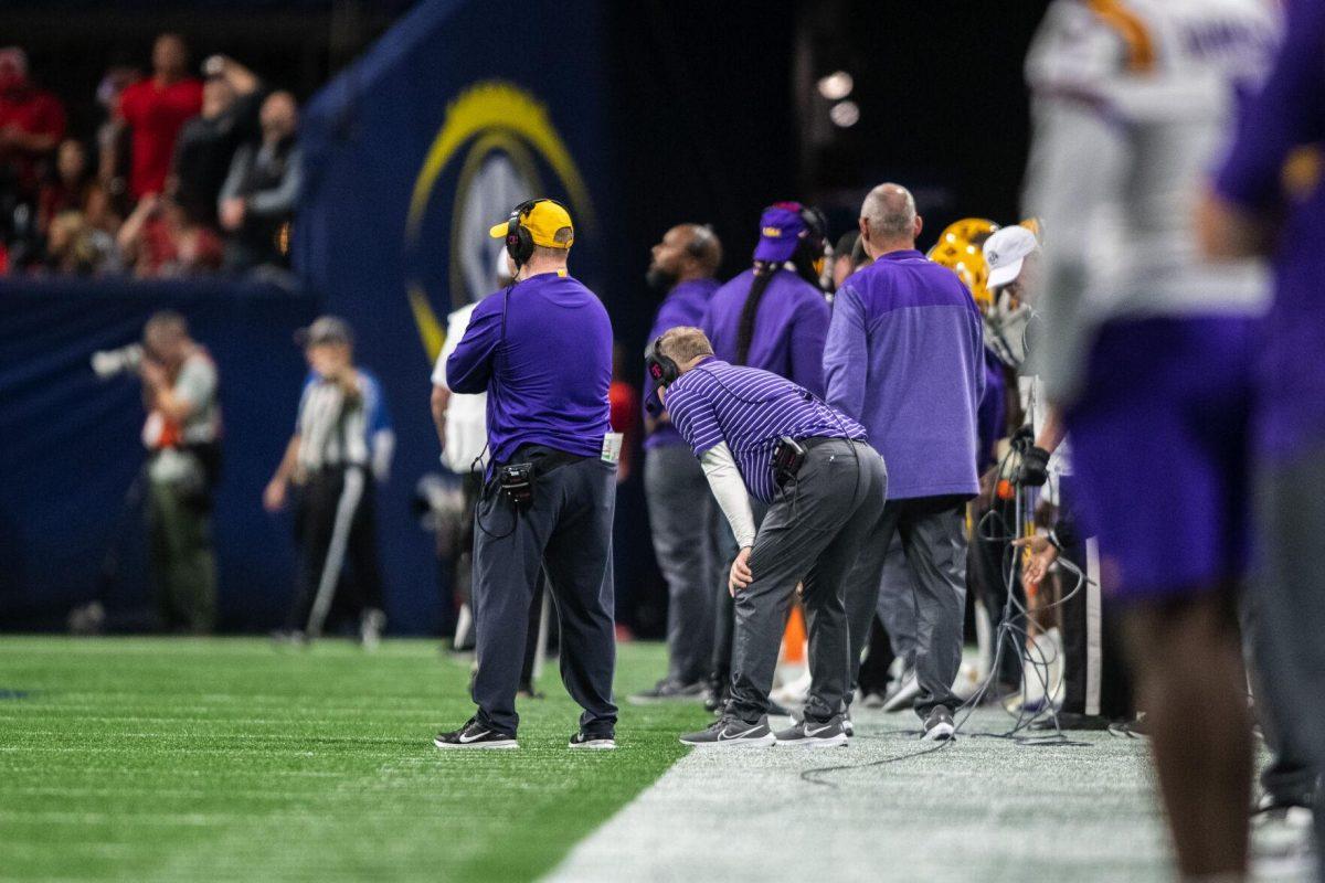 LSU football head coach Brian Kelly watches the game with his hands on his knees Saturday, Dec. 3, 2022, during LSU's 30-50 defeat to Georgia at the Southeastern Conference Championship at the Mercedes-Benz Stadium in Atlanta, Georgia.