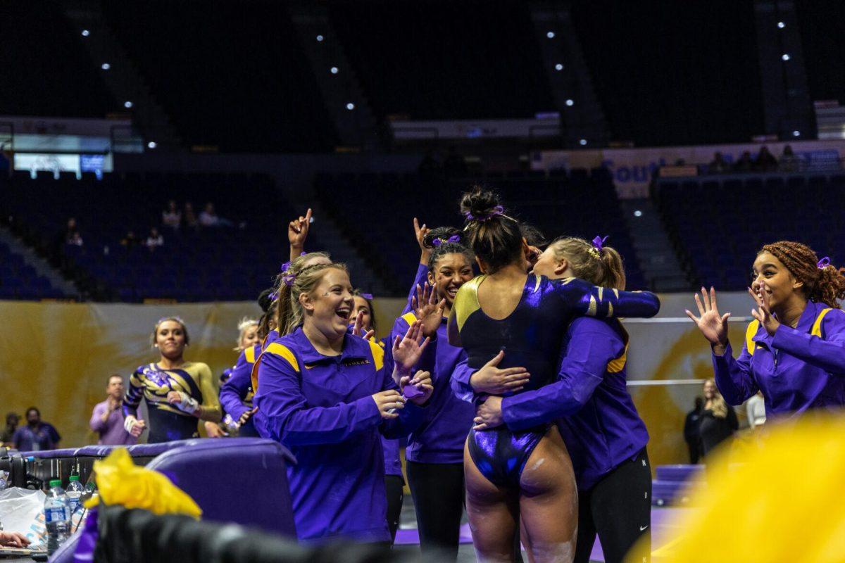 The LSU gymnastics team celebrates with sophomore all-around Aleah Finnegan Monday, Dec. 12, 2022, during the annual "Gym 101" showcase in the Pete Maravich Assembly Center.